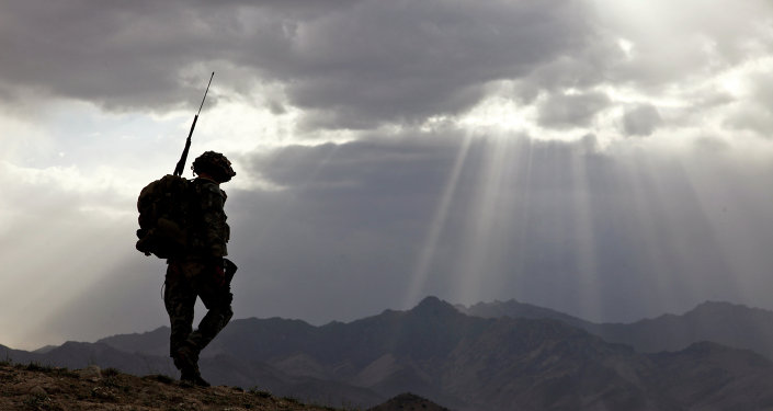 US Army Spc. Newton Carlicci travels dismounted while on his way back to his outpost from the village of Paspajak, Charkh District, Logar province, Afghanistan. File photo